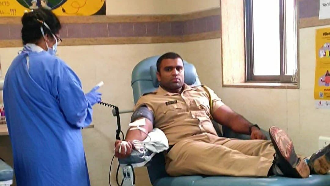 Amid cyclone, police officer comes to rescue.