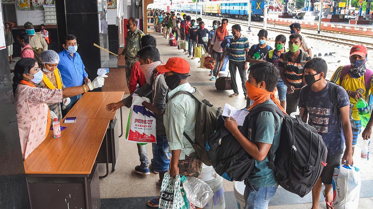 Migrants from Goa undergo thermal screening after arriving by a special train at Danapur railway station to reach their destination, during ongoing COVID-19 nationwide lockdown, in Patna on Tuesday, 2 June. 