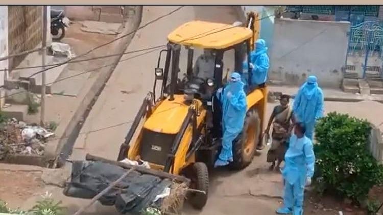 The body of a man who died from COVID-19 in Andhra Pradesh was taken to a burial ground in a JCB earthmover machine.