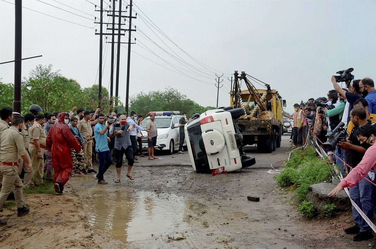 Police and media at the encounter site where gangster Vikas Dubey was killed when he allegedly tried to escape from the spot following an accident, near Kanpur, on Friday, 10 July.
