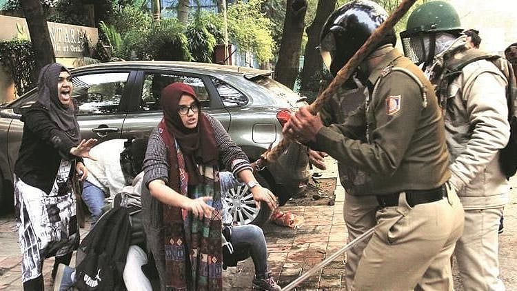 Image of students of Jamia trying to protect another student from police violence, used for representational purposes.