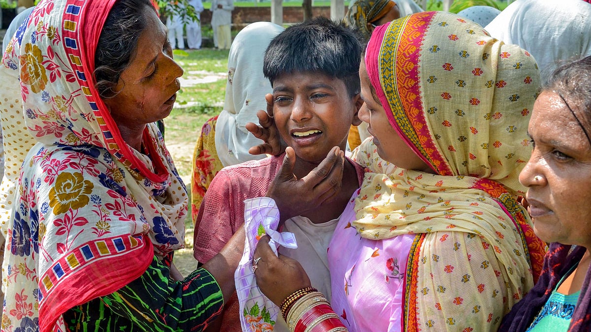 A boy grieves the death of his father from drinking spurious liquor at Mucchal village, near Amritsar. As many as 121 people have died in the Punjab Hooch tragedy.  &nbsp;