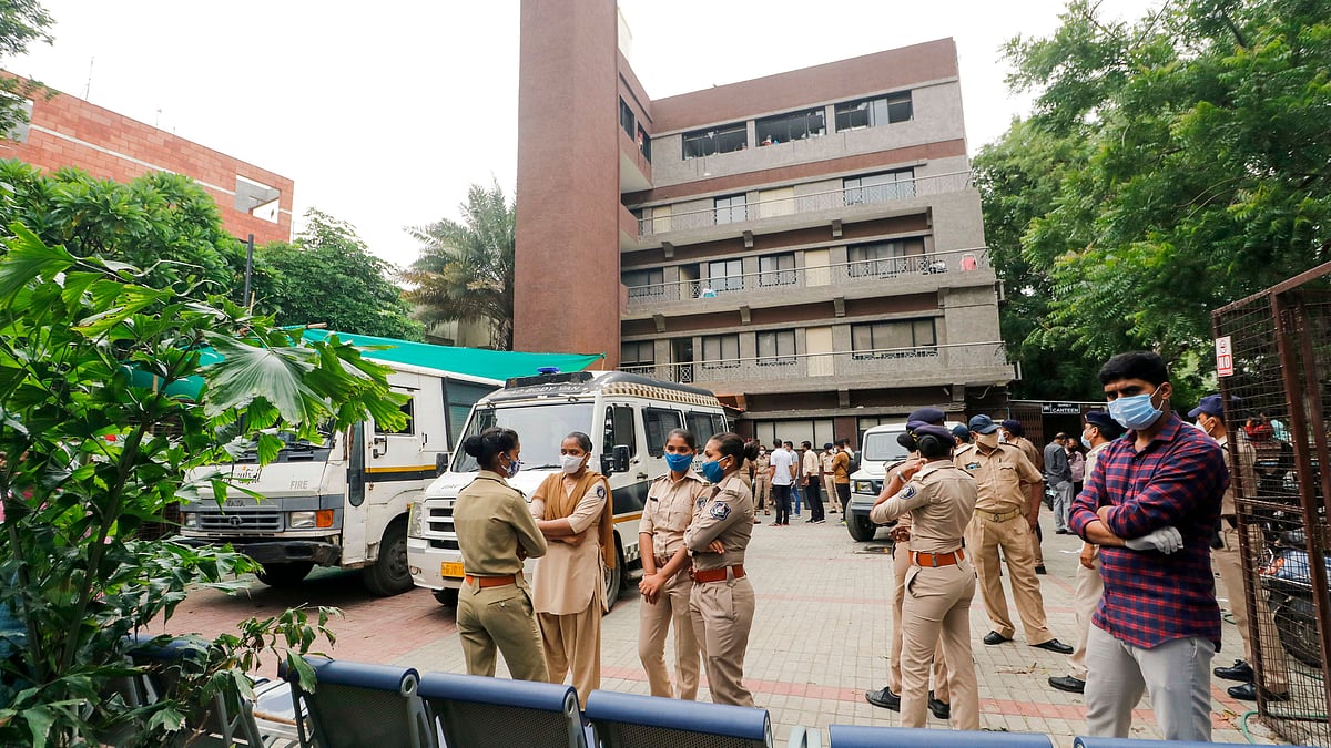Police stand outside Shrey Hospital after a major fire broke out on Thursday.