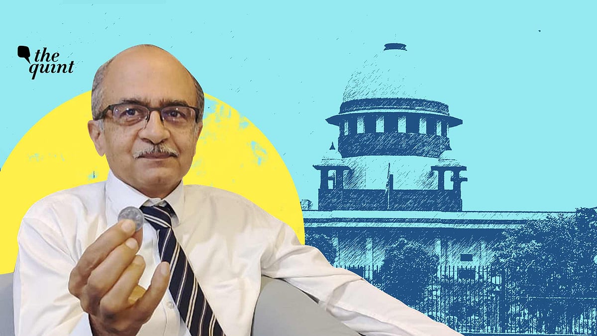 Prashant Bhushan holds up a Re 1 coin given to him by his lawyer Rajeev Dhavan after the court announced its sentence.