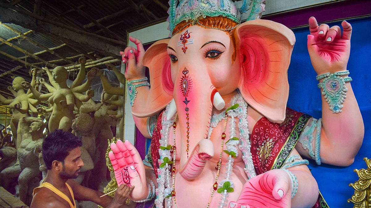An artisan gives final touch to idols of Lord Ganesha on the eve of Ganesh Chaturthi festival, in Nadia district, Friday, 21 August 2020.