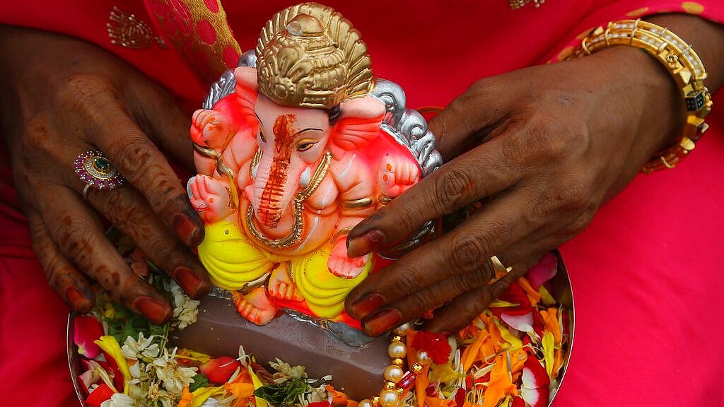 A woman carries an idol of Hindu god Ganesha to immerse it in Hussain Sagar Lake on the final day of Ganesha Chaturthi festival in Hyderabad, on Thursday, 12 September 2019. Image used for representational purpose.