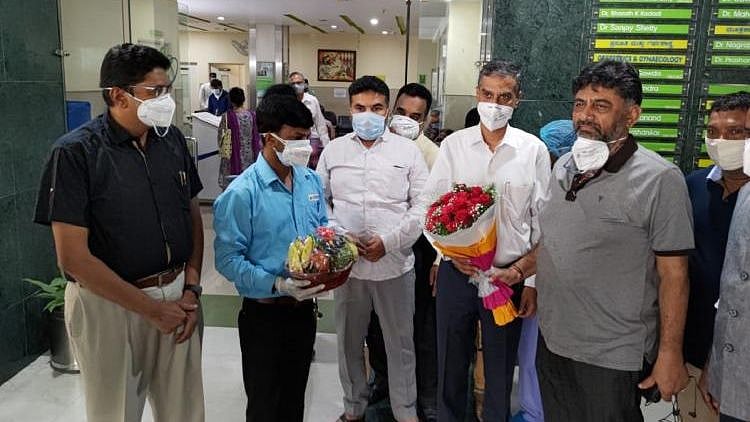 Photographs emerged showing DK Shivakumar standing outside the out-patient department section of Suguna Hospital.