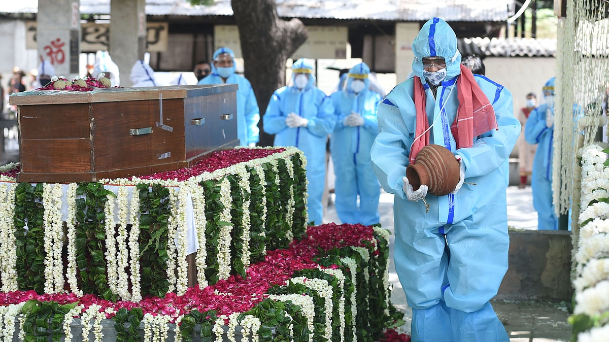 Abhijit Mukherjee, son of late Pranab Mukherjee, performs rituals during the cremation of the former president, at Lodhi Road cremation ground in New Delhi, Tuesday, Sept. 1, 2020. 
