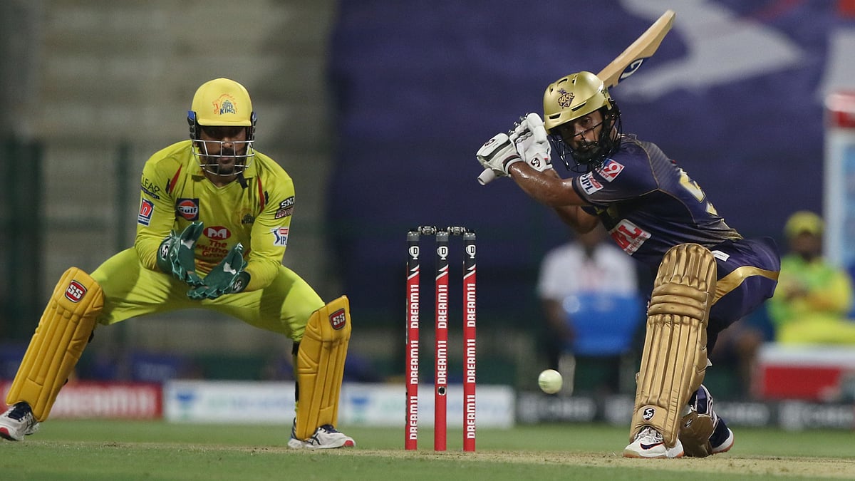 KKR opener Rahul Tripathi plays a shot against Chennai Super Kings, as Mahendra Singh Dhoni looks on.