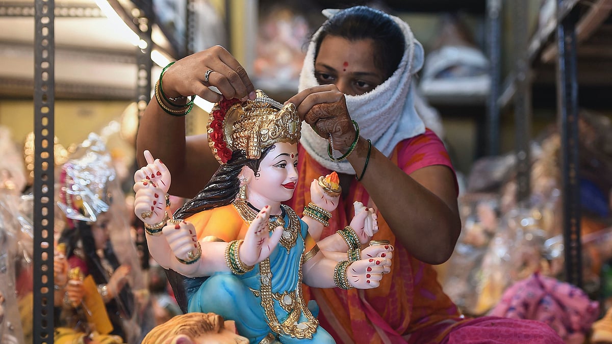 An artisan gives a finishing touch to an idol of Goddess Durga for the upcoming Durga Puja festival, at Lalbaug in Mumbai.