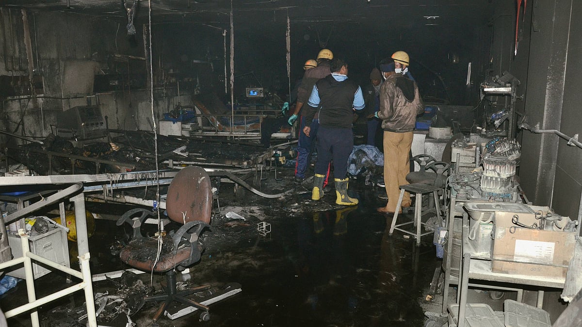 Firefighters inside the ICU of a COVID-19-designated hospital where the fire broke out in Rajkot, on Friday, November 27.
