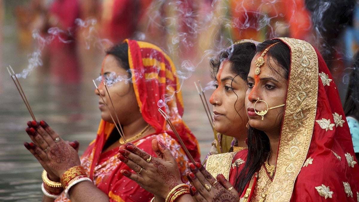  Devotees pray to the Sun God in a pond on the occasion of Chhath Puja, in Agartala, Friday, 20 November.