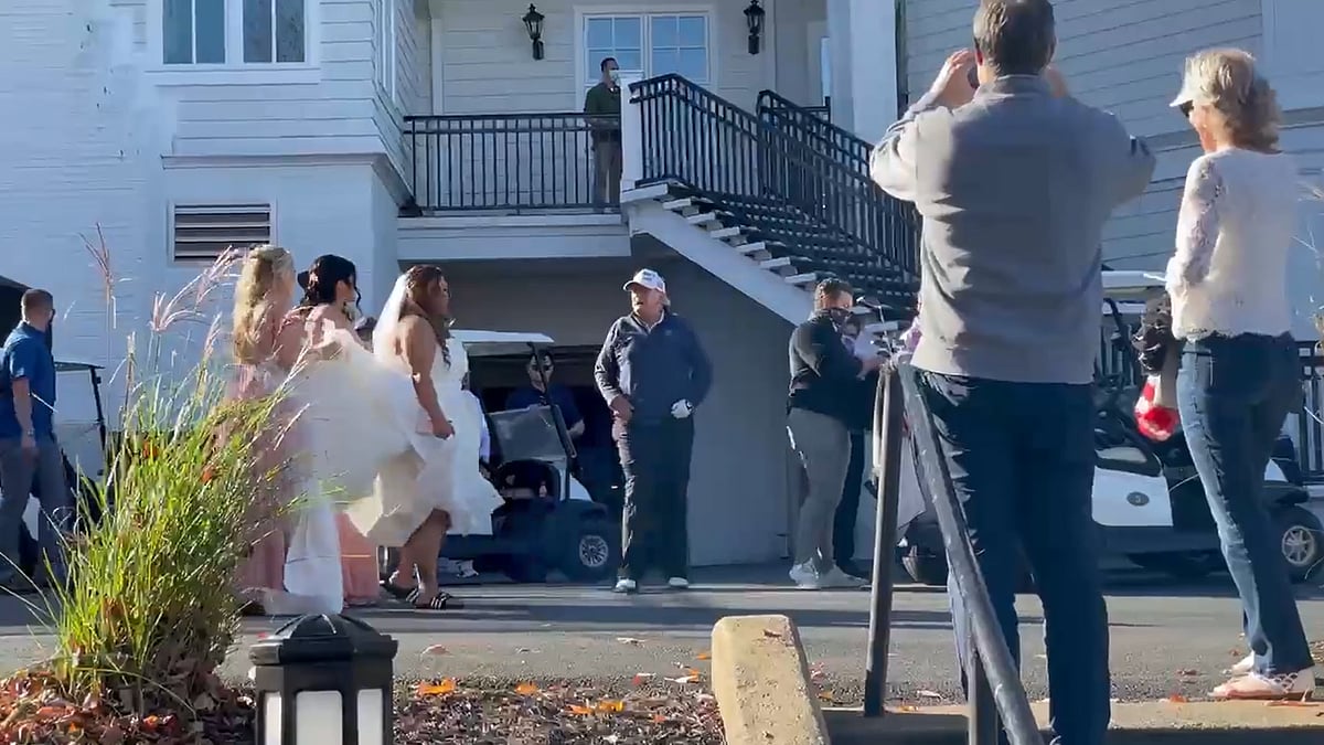 A screen grab of a video of Trump posing for pictures at the Trump National Golf Course.