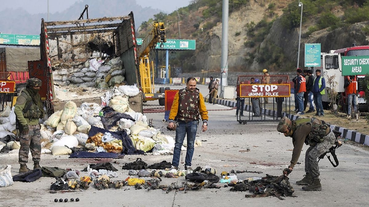Security personnel inspect the site of encounter at Nagrota Ban toll plaza on 19 November .