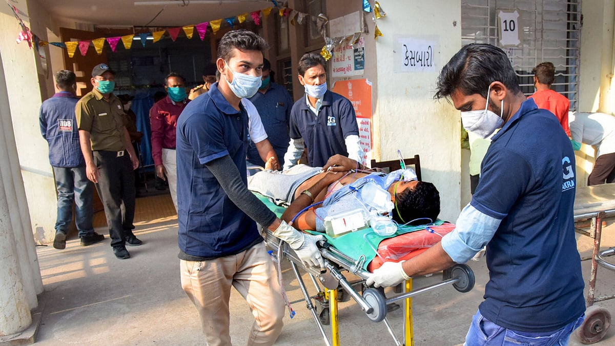 An injured person being moved to a hospital after the mini-truck in which he was travelling rammed into another truck, on the outskirts of Vadodara