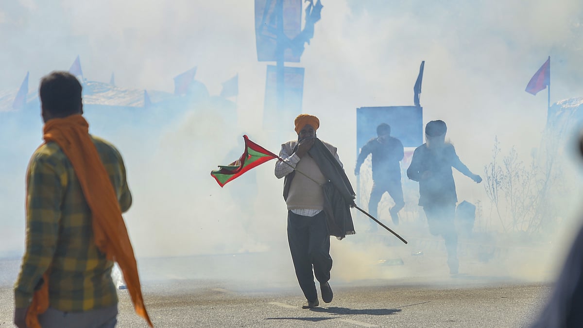 Security personnel use tear gas to stop farmers from crossing the Singhu Border during the “Delhi Chalo” protest march against the new farm laws, in New Delhi, Friday, 27 November.