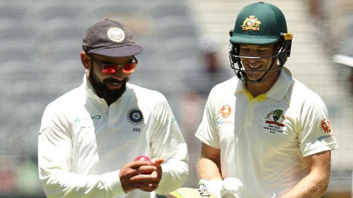Virat Kohli and Tim Paine share a light moment.&nbsp;