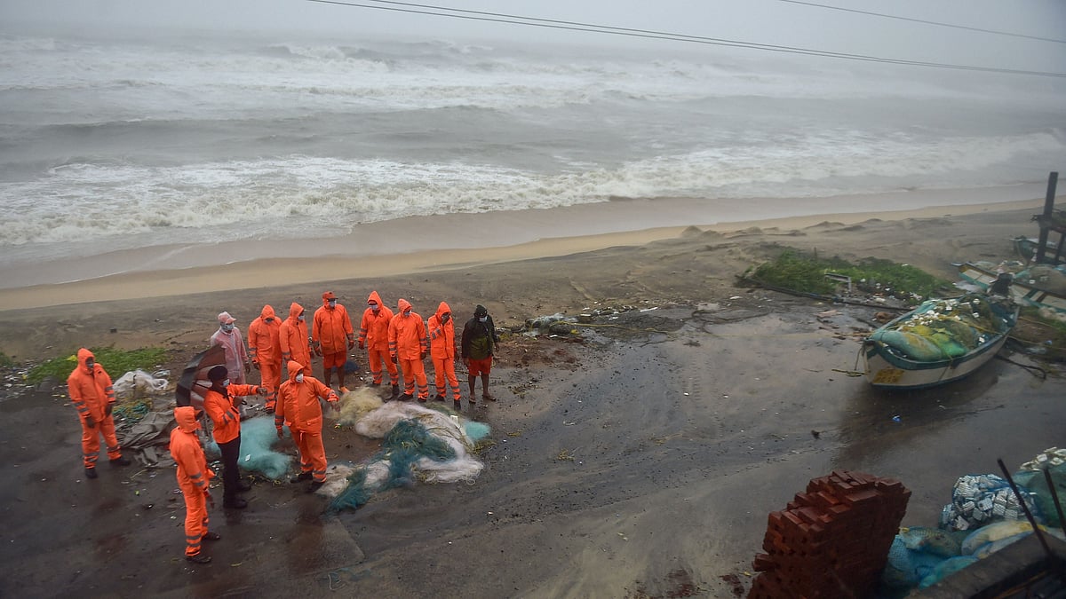  NDRF personnel inspect an area of Devanerikuppam near Mamallapuram before the landfall of Cyclone Nivar, in Mamallapuram, Wednesday.