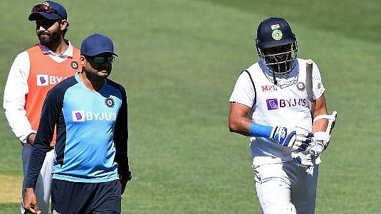 Mohammed Shami walks off the field after injuring his arm in Adelaide. 