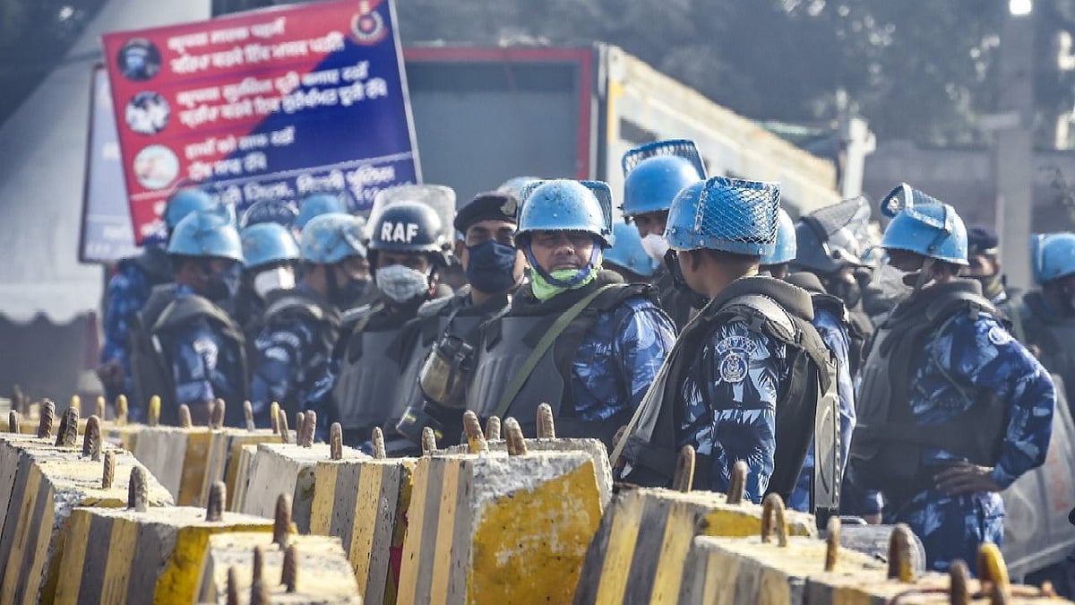 Security personnel stand guard at the Singhu border during the ongoing farmers’ protest against the farm laws.