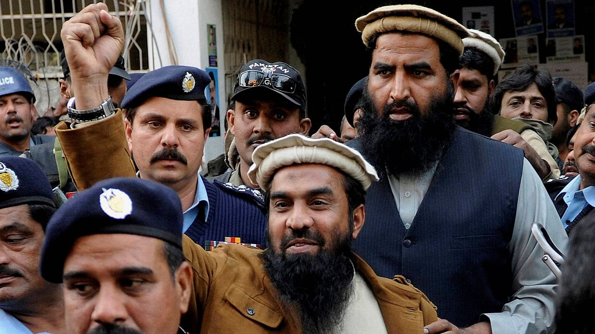 Zaki-ur-Rehman Lakhvi, the main suspect of the Mumbai terror attacks in 2008, raises his fist after his court appearance in Islamabad, Pakistan.