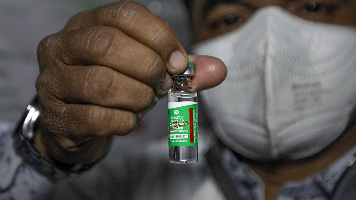 A health worker shows the ‘Covishield’ after the arrival of the first batch of the vaccines from the Serum Institute of India at the Civil Hospital in Ahmedabad.
