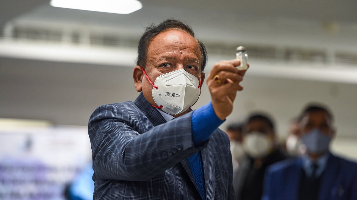 Union Health Minister Harsh Vardhan displays a Covishield vaccine vial, after the virtual launch of COVID-19 vaccination drive by Prime Minister Narendra Modi, at AIIMS in New Delhi on Saturday.
