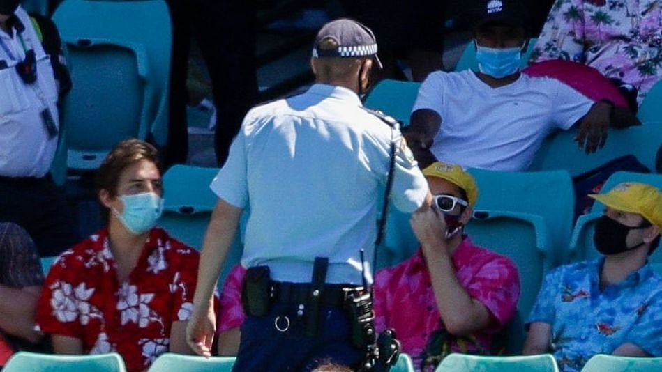 Police talk to spectators as the game is stopped after a complaint by Indian players during Day four of the third  test between India and Australia at the Sydney Cricket Ground.