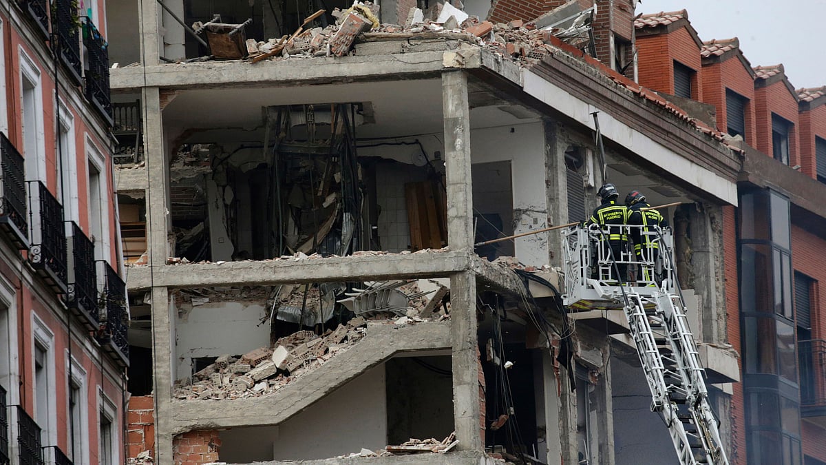 Fire-fighters work on a damaged building at Toledo Street following an explosion in downtown Madrid, Spain, Wednesday, 20 January. A loud explosion of unknown origin has partially destroyed a six-floor-tall building flanked by a school and a nursing home in the center of Spains capital, Madrid.