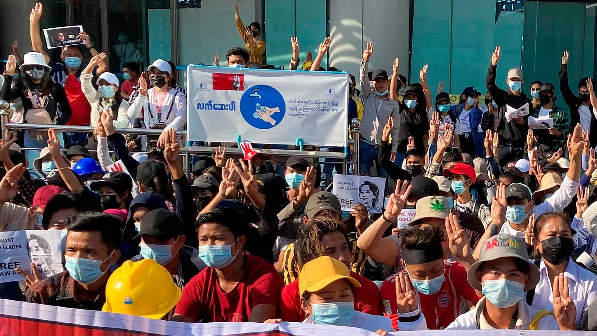 Demonstrators display three-fingered salute, a symbol of resistance at an intersection in Yangon, Myanmar. Image for representational purposes.&nbsp;