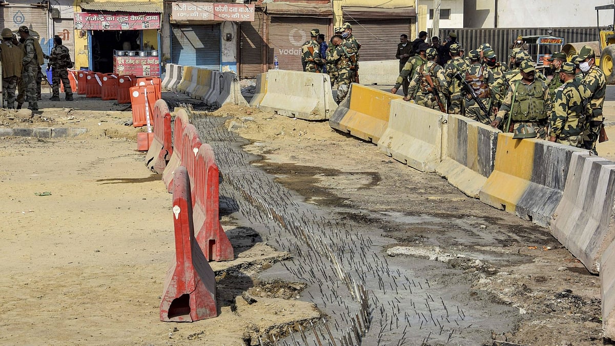 Police personnel placed iron nails near the barricades in an attempt to stop farmers from crossing the Tikri Border as their agitation against the new farm laws continues, in Delhi on Monday, 1 February.