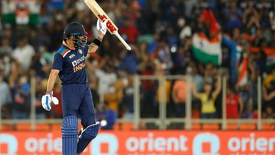 Virat Kohli acknowledges the cheers from the crowd after completing his half-century 