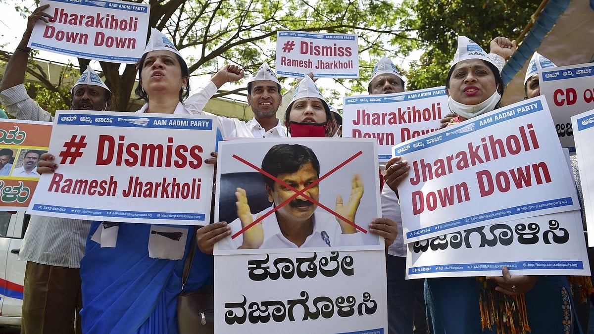 Members of the Aam Aadmi Party raise slogans against Karnataka Minister Ramesh Jarkiholi for his alleged involvement in CD row in Bengaluru, Wednesday, 3 March, 2021. 
