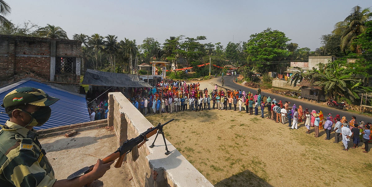 Nandigram: Voters stand in queues to cast their votes amid security during the second phase of West Bengal Assembly polls, in Nandigram.