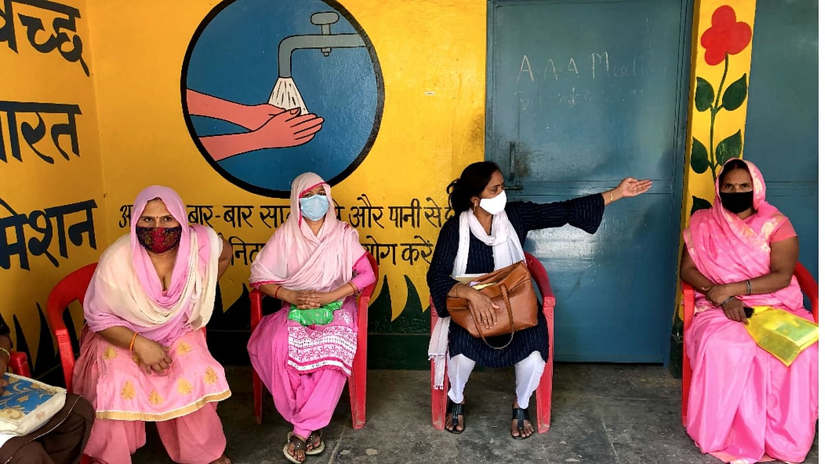 ASHA workers meeting the village <i>pradhan</i> in Meerut’s Gagol village.