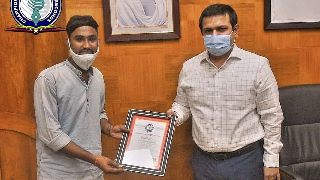 <div class="paragraphs"><p>Kaki Santosh receiving an award for her service from the district collector.</p></div>