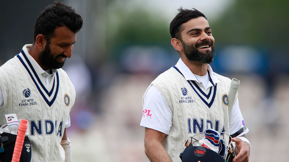 Virat Kohli and Cheteshwar Pujara share a light moment during Day 2 of the WTC Final.&nbsp;