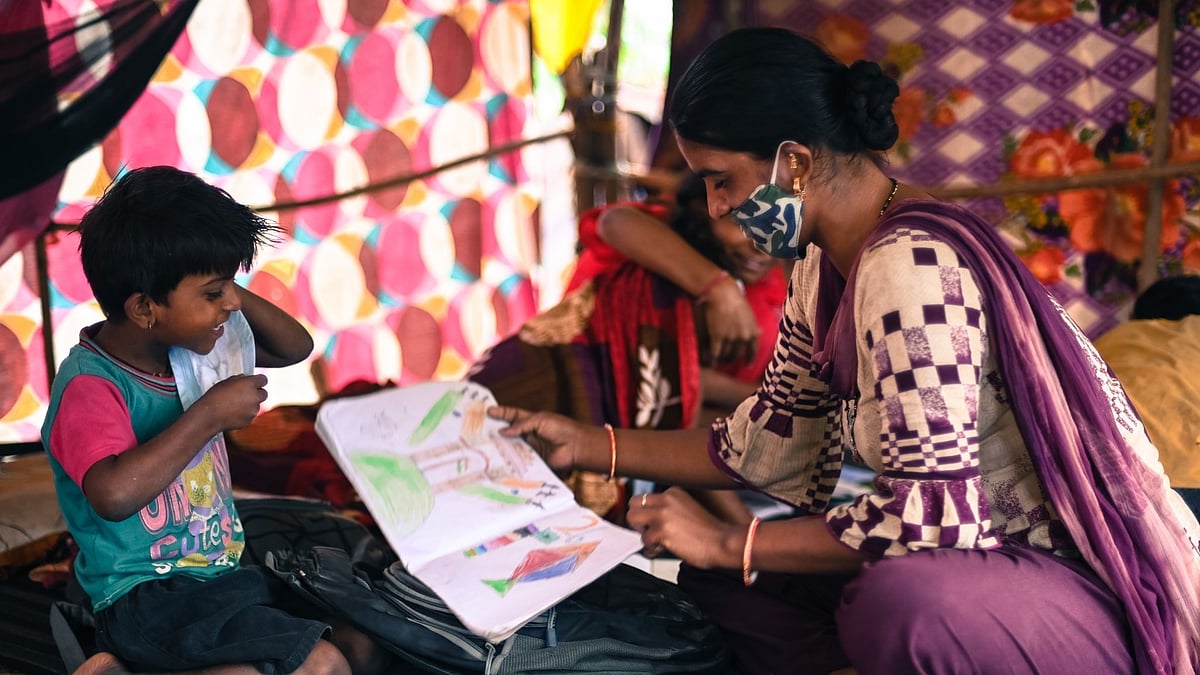 Reshma, 30, plays with her children at the Signature bridge refugee camp in New Delhi.