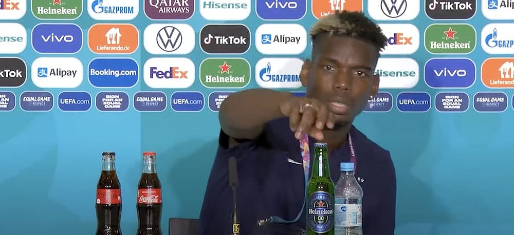 French midfielder Paul Pogba removing the beer bottle. 