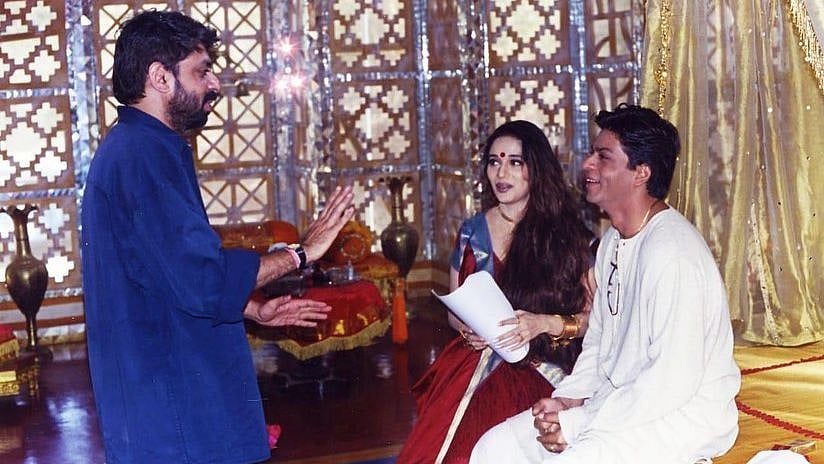 <div class="paragraphs"><p>Shah Rukh Khan, Madhuri Dixit and Sanjay Leela Bhansali on the sets of <em>Devdas</em>.</p></div>