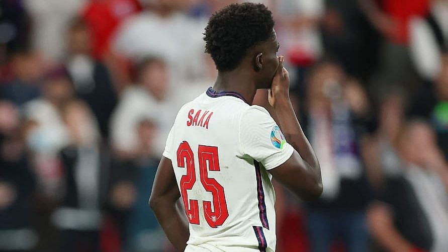 <div class="paragraphs"><p>Bukayo Saka reacts after missing his penalty against Italy in the Euro 2020 final. </p></div>