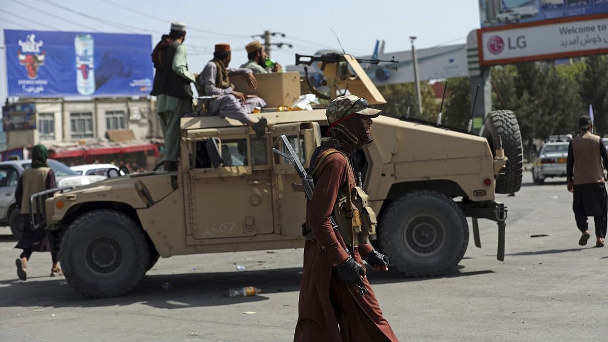 <div class="paragraphs"><p>Taliban fighters stand guard in front of the Hamid Karzai International Airport, in Kabul, Afghanistan. </p></div>