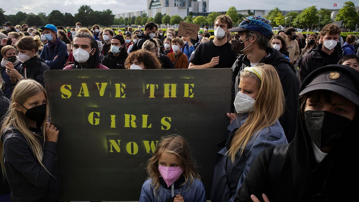 <div class="paragraphs"><p>People hold a poster demanding the security of girls in Afghanistan during a demonstration in Berlin, Germany, on Tuesday. Hundreds of people attended a demonstration to support an air bridge to bring people out of the Taliban-controlled country.</p></div>
