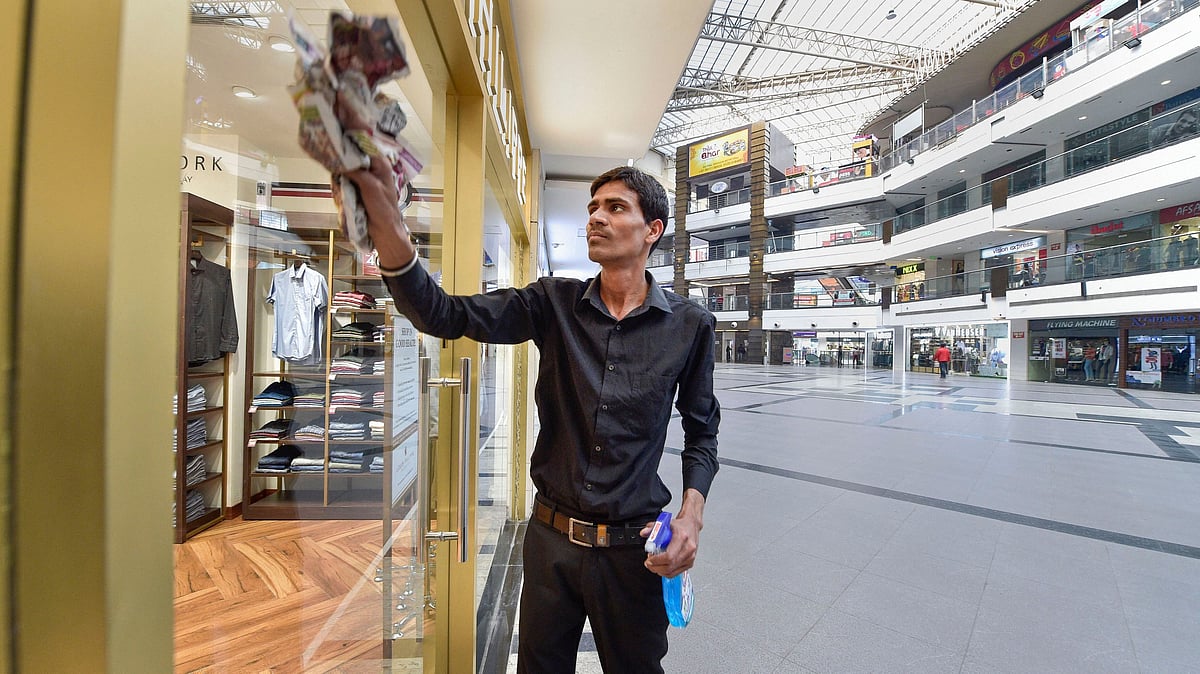 <div class="paragraphs"><p>A worker cleans the glass windows of a showroom at a mall in the wake of the coronavirus pandemic. Image used for representational purposes.</p></div>