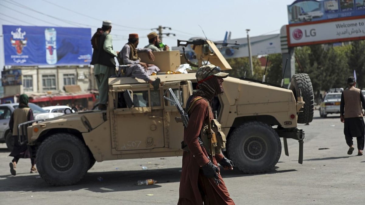 <div class="paragraphs"><p>Taliban fighters stand guard in front of the Hamid Karzai International Airport, in Kabul, Afghanistan.</p></div>