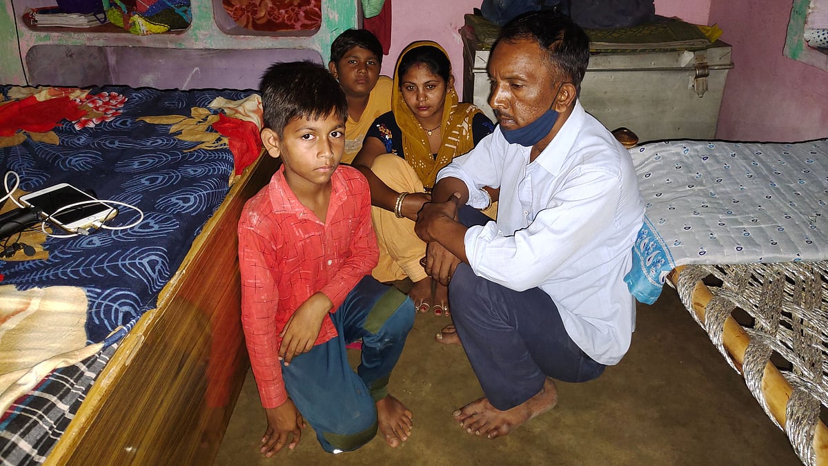 <div class="paragraphs"><p>Ashok Kumar sitting in his house with his wife and two sons</p></div>