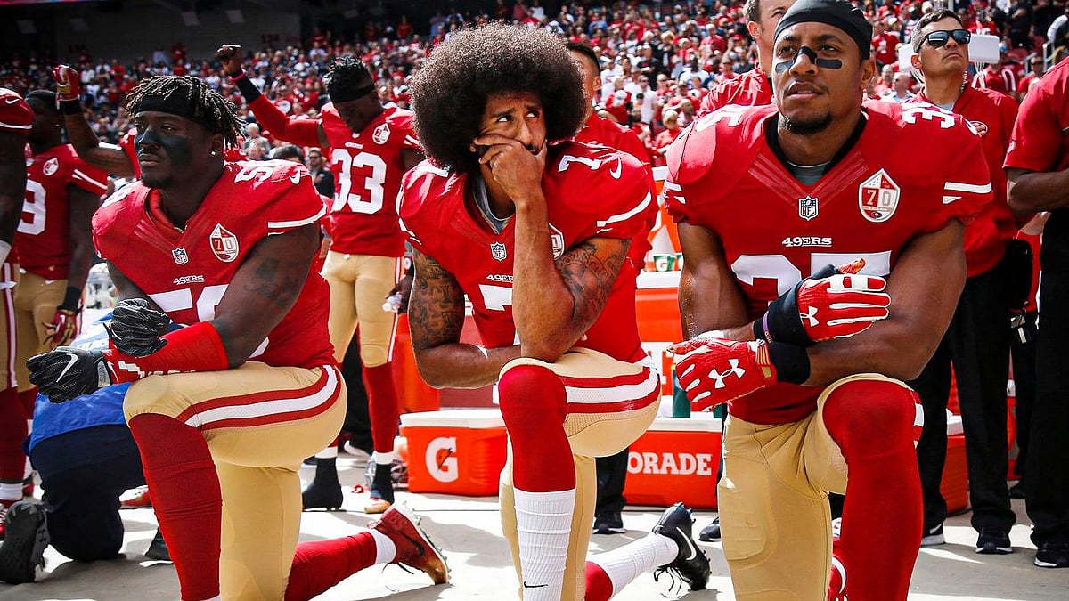 <div class="paragraphs"><p>Colin Kaepernick (center) with Eli Harold (left) and Eric Reid (right) kneel during the national anthem before their NFL game in 2016. </p></div>