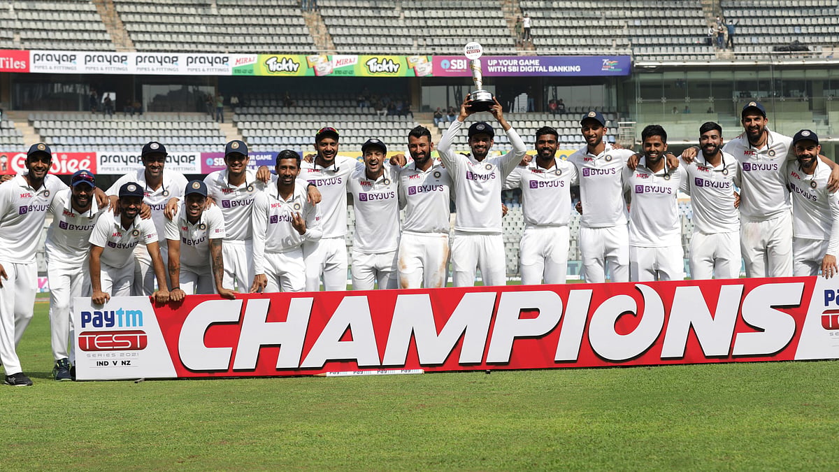 <div class="paragraphs"><p>India players pose with the trophy after beaten New Zealand 1-0 in the Test series.</p></div>