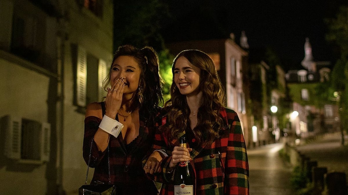 <div class="paragraphs"><p>Ashley Park as Mindy and Lily Collins as Emily in a still from Netflix's <em>Emily in Paris.</em></p></div>