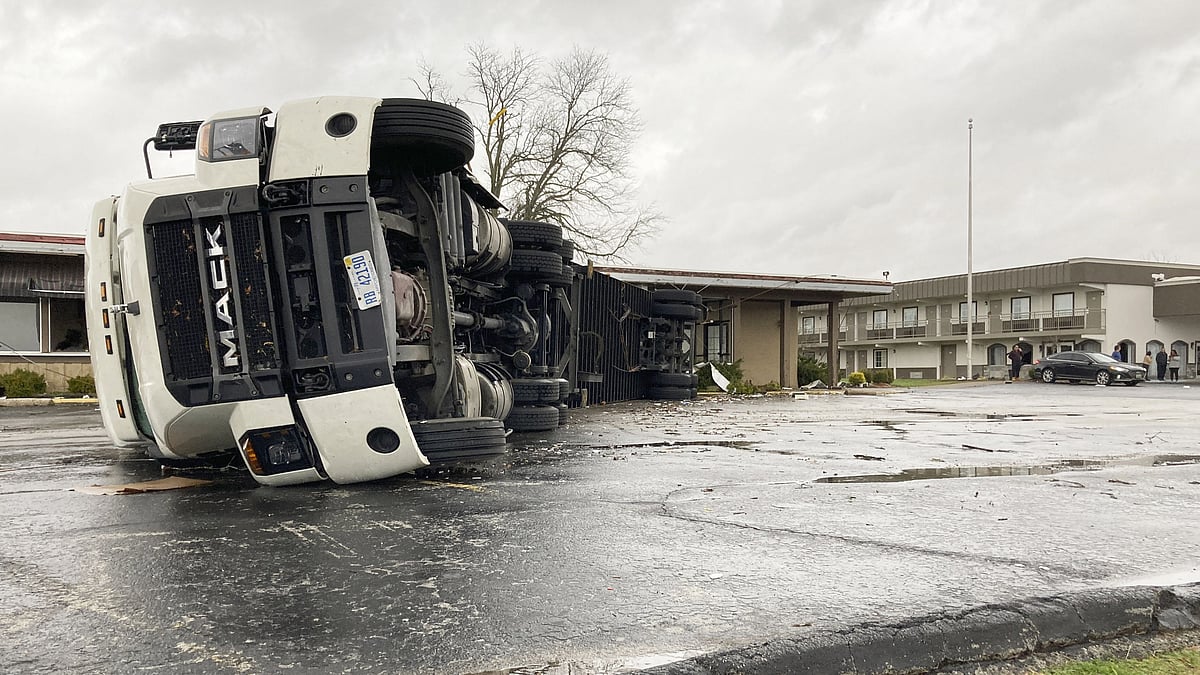 <div class="paragraphs"><p>A large semi trailer is flipped over and pushed against a building in Bowling Green, Kentucky, on Saturday, 11 December 2021.</p></div>